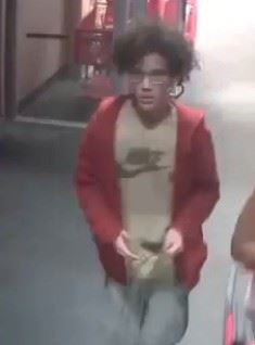 black woman in pink tank top pushing shopping cart